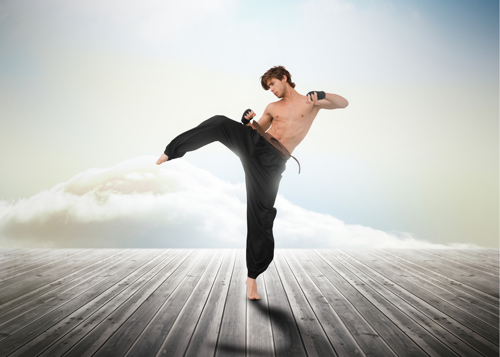 Martial arts fighter over wooden boards leading out to the horizon