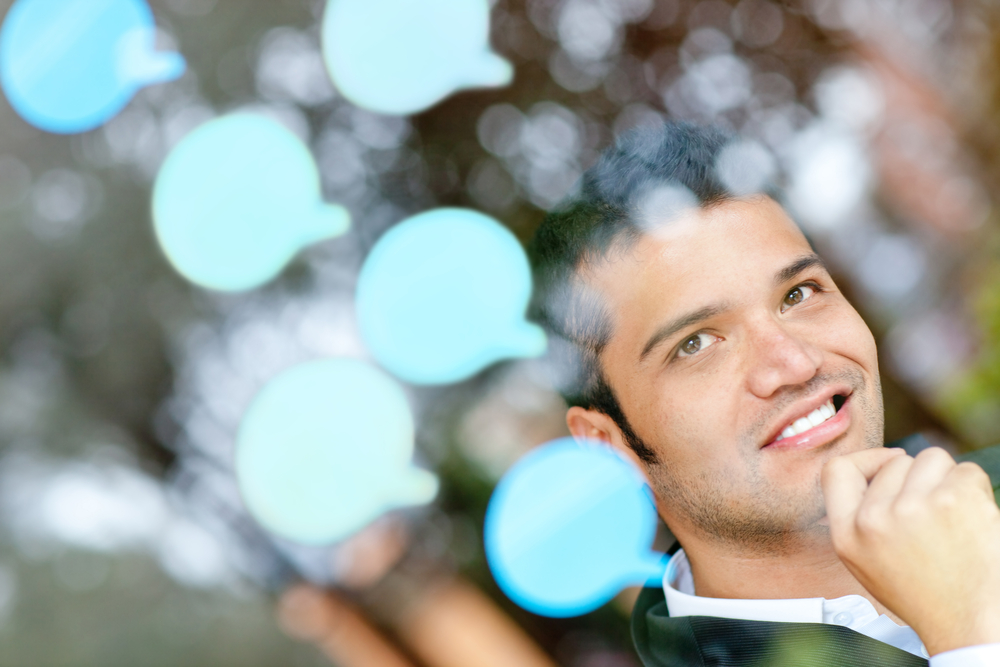 Pensive business man with thought bubbles around his head