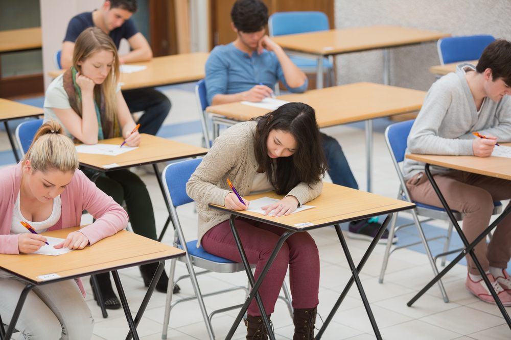 Students writing in the exam hall of the college